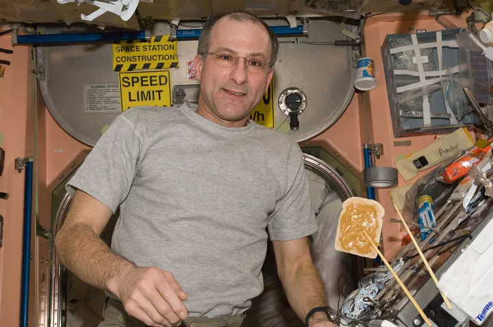 ISS-30 Don Pettit is pictured near a snack floating freely in the Unity node